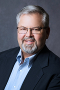 Commissioner jeff fix man posing wearing a suit and tie