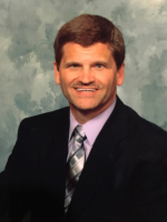 keller man in a suit and tie standing