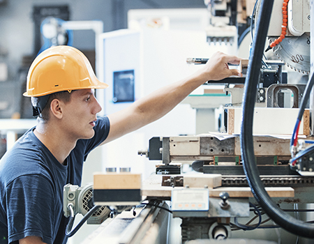 Worker operating machinery at a Fairfield County manufacturing plant