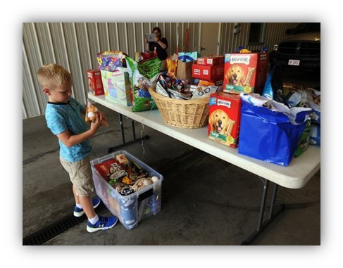 kid looking at donations on table