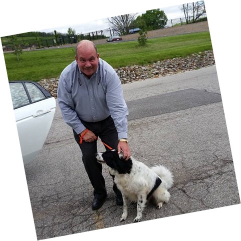 man standing with dog