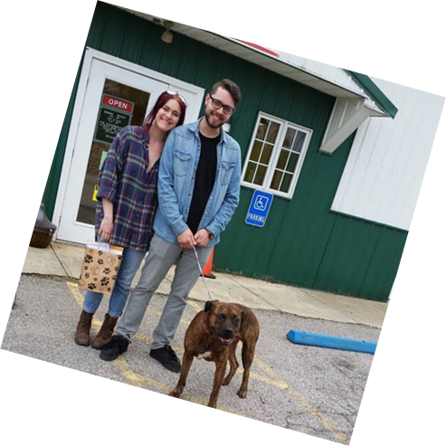 couple standing with dog